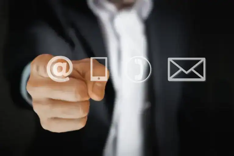 Businessman pointing at different icon representing email, phone and messages icons, symbolizing contact options for Mellonne's Smart Card Testing Solutions