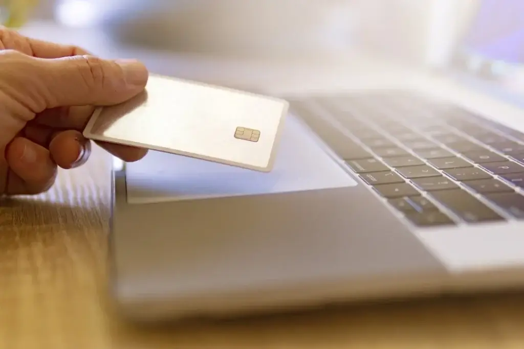 Hand showing a test smart card, representing Mellonne's American Express Test Smart Cards for reliable transaction security testing