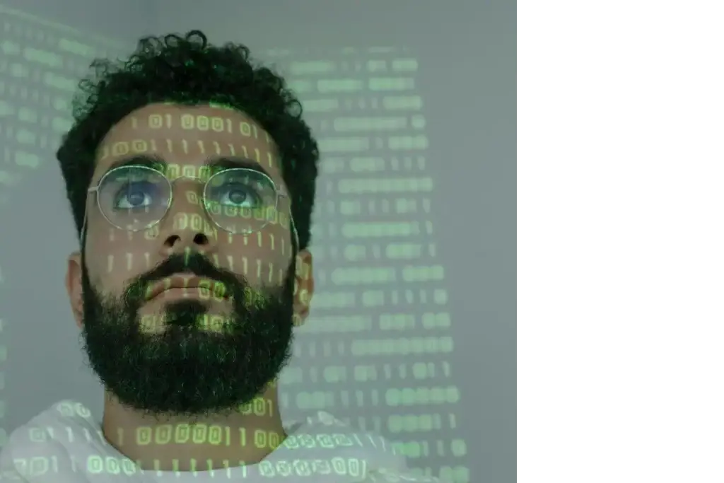 Portrait of a developer with projected code, representing Mellonne's expertise in automated test plans expertise with structure and scalable test strategies